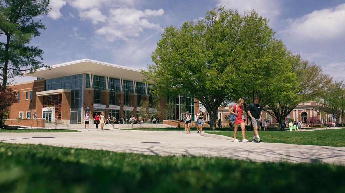 The Janet Morgan Riggs student center with students walking in the foreground