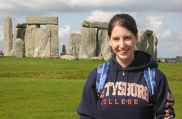 A history major student standing in front of Stonehenge