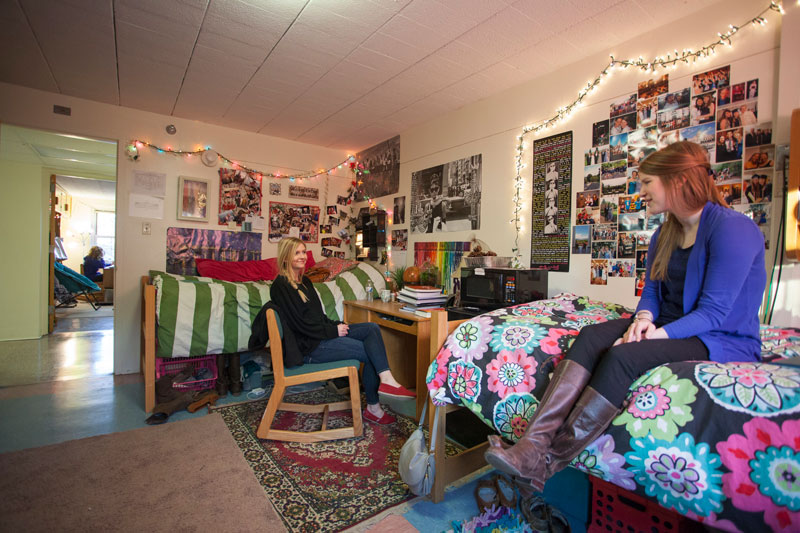 Two female college students inside their dorm room