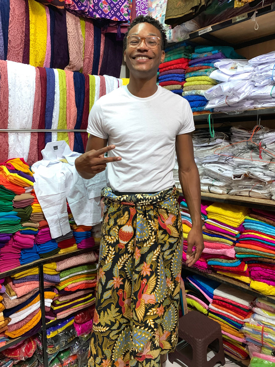Churon T. Lanier-Martin in a clothing store in Bali wearing traditional Balinese clothes