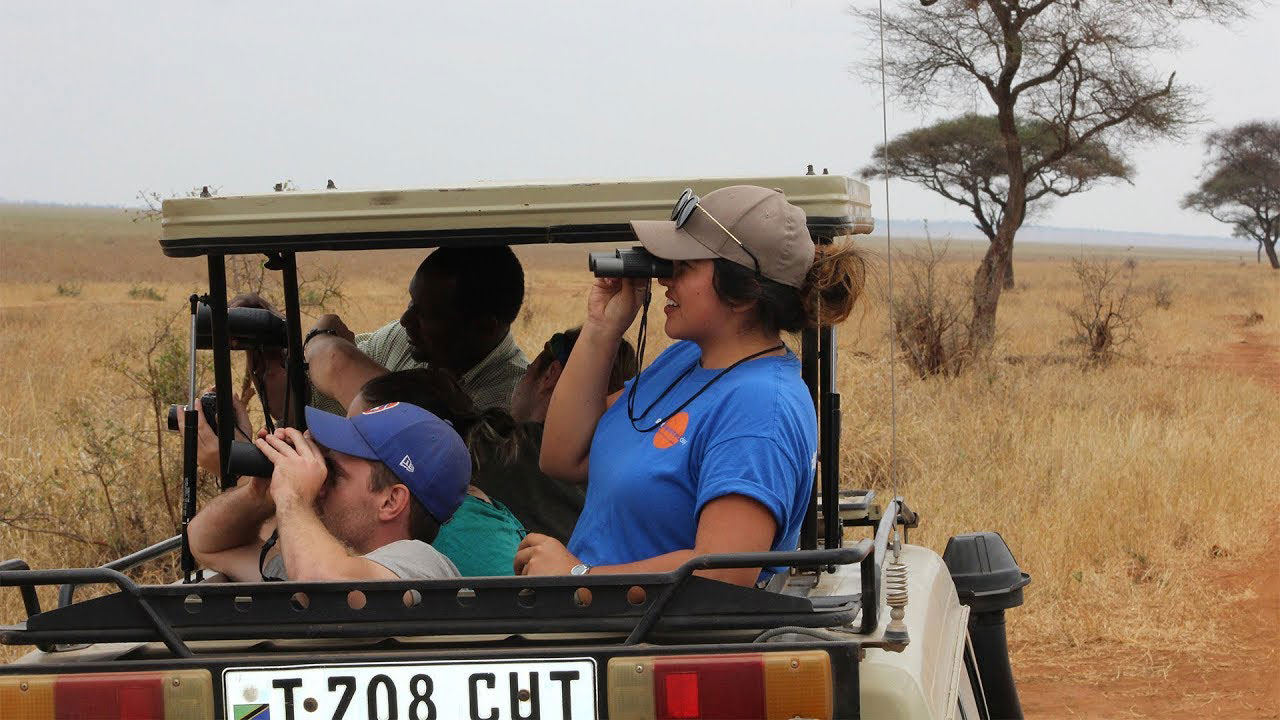 Venissa Ledesma 19 using a telescope on a jeep car in Tanzania