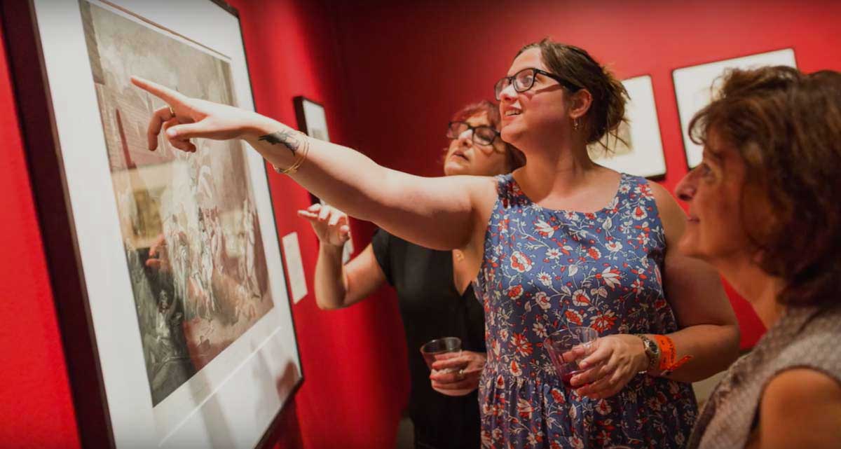 Bailey Harper ’19 pointing at a photo in The Plains of Mars exhibition