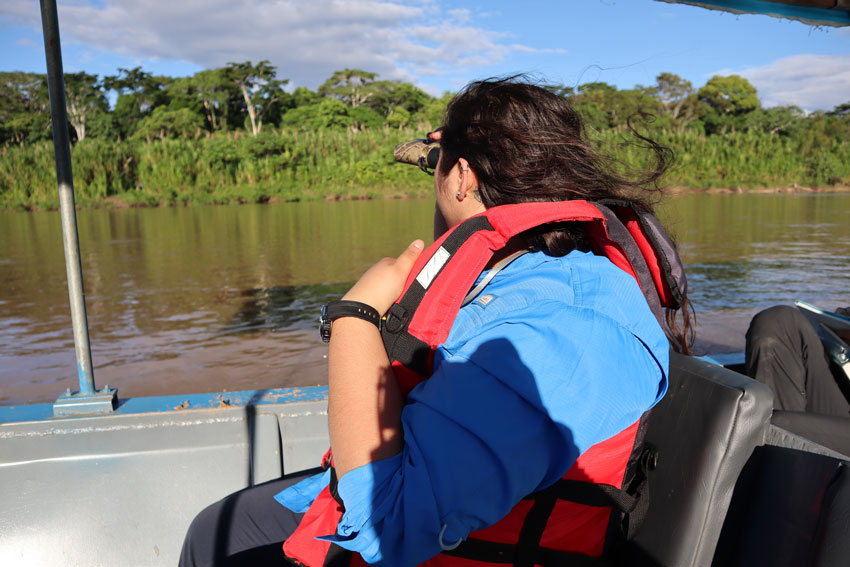 student on a boat in a river in the Amazon rainforest