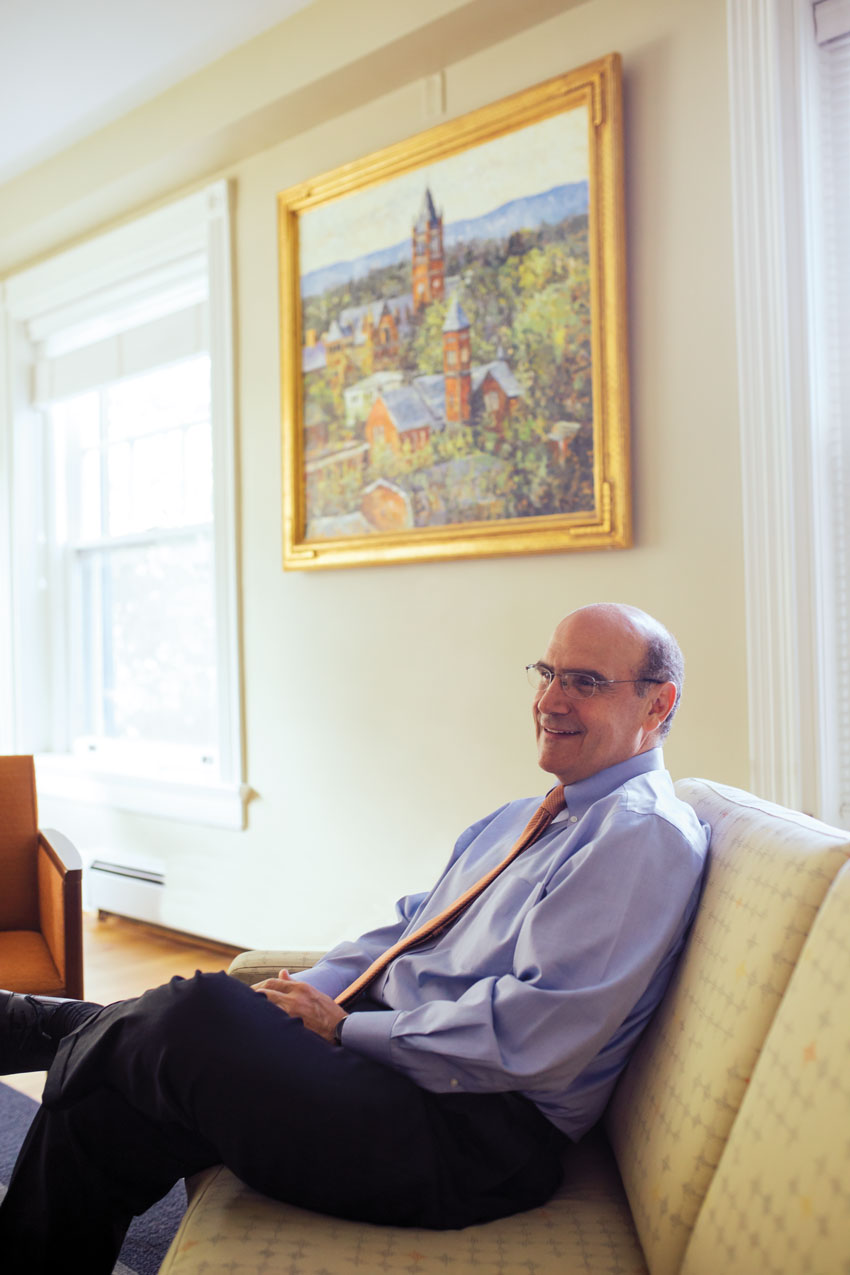 Bob Iuliano sitting with a painting of historic Gettysburg College