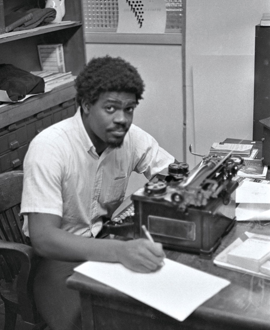 Leon Glover '71 writing at his desk