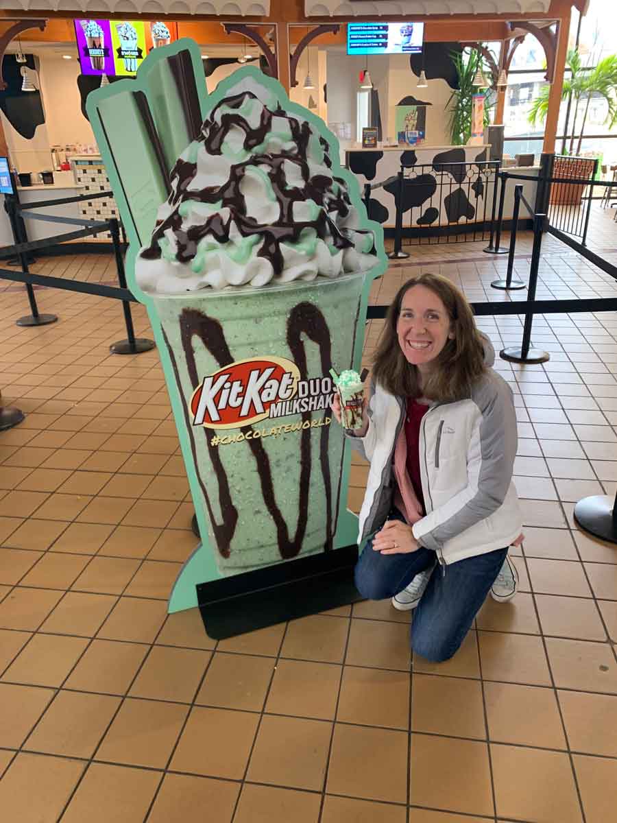 Kimberly McMenamin posing with a Kit Kat milkshake at Hershey Park's Chocolate World