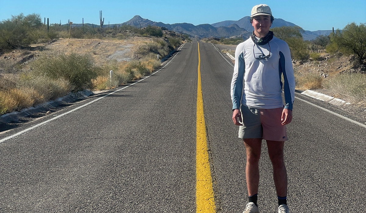Chris Mergner stands on a road in Baja