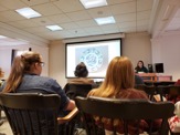 Students watching an Alumni talk in a classroom