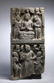 Buddhist stone carving with religious imagery on it