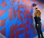 Sneha Shrestha painting a mural