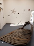 Curved wooden sculpture in an art gallery