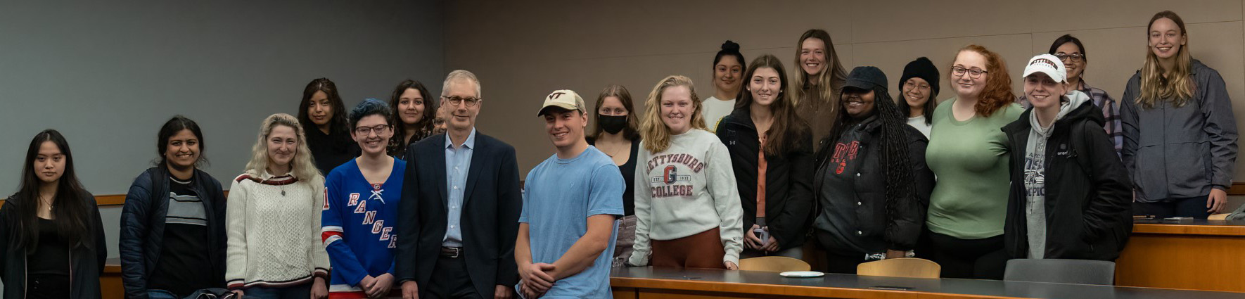 An image of a professor with a group of students.