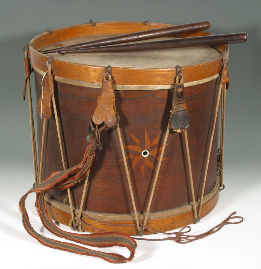 Picture of a civil war era drum with drum sticks on top