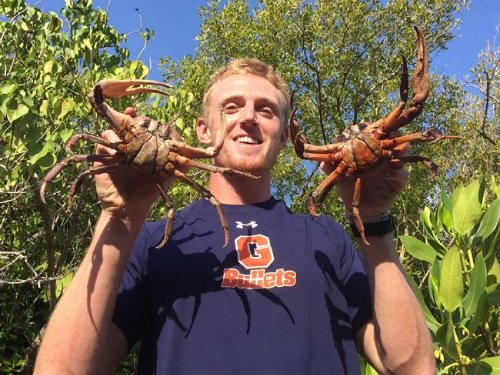 Cody displaying two crabs