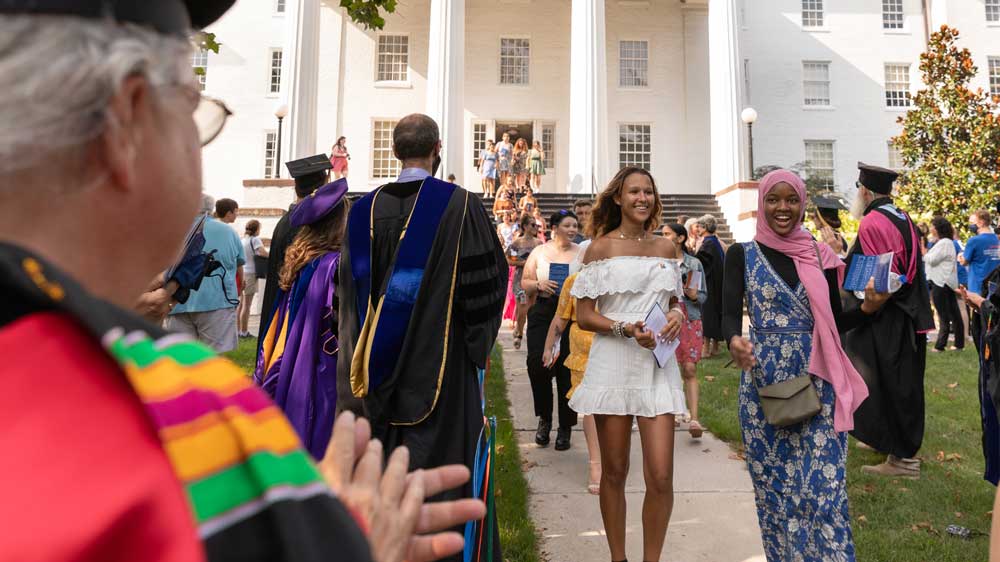 Students walking away from Penn Hall