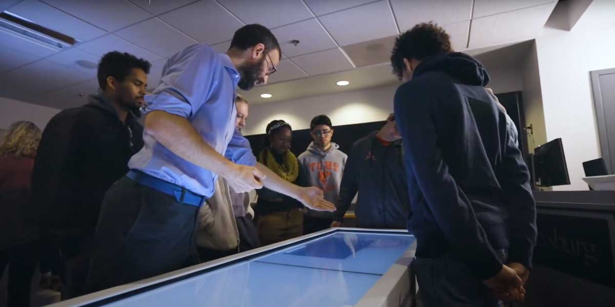 Faculty member teaching students over an Anatomage table