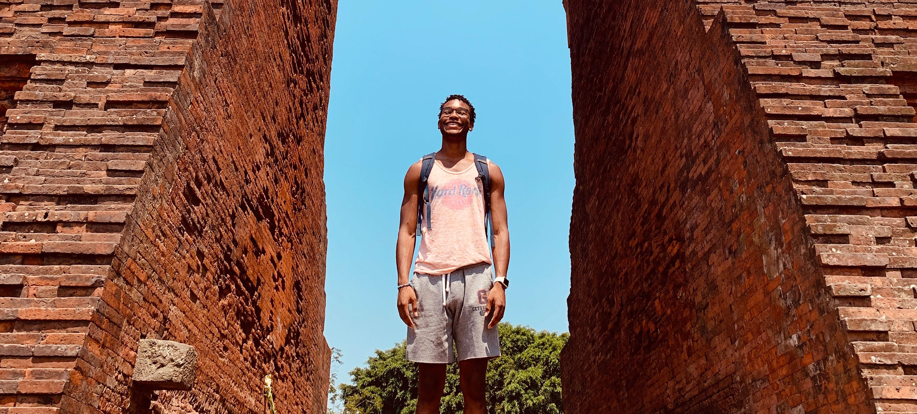 Churon T. Lanier Martin standing inside an ancient Hindu temple in Trowulan, Java