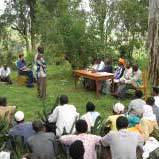 People crowded around a table outdoors