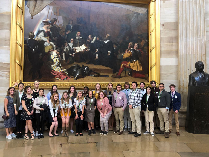 Students posing with painting Students posing with painting