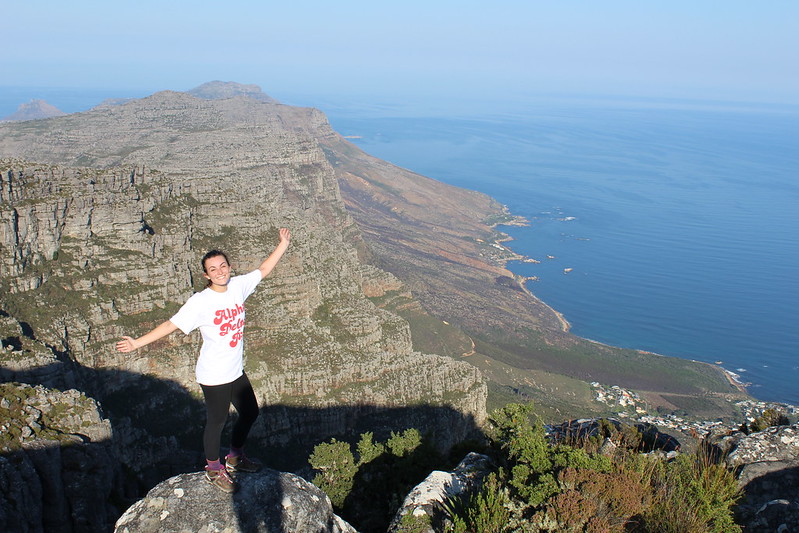 A student stands on a rocky mountain