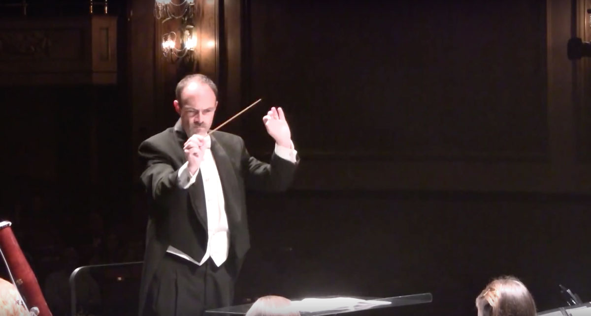 Professor Russell McCutcheon conducting on stage