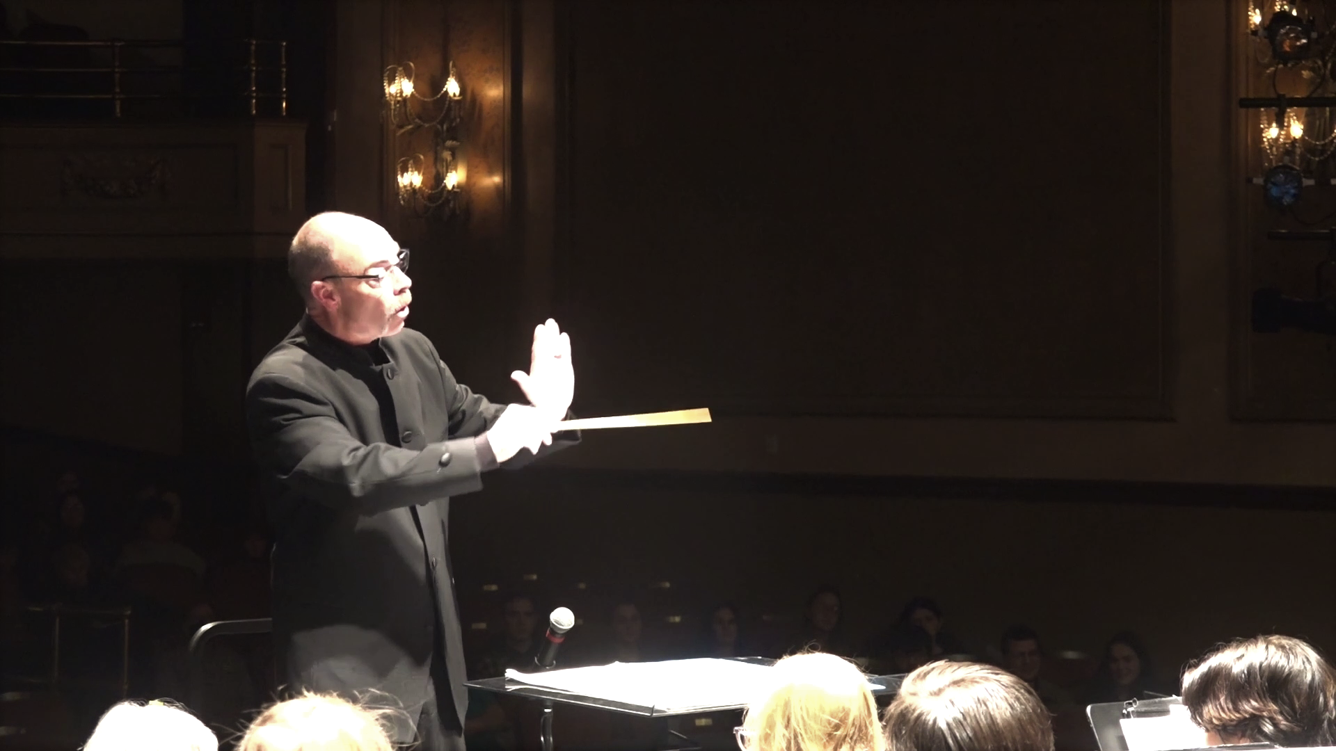 Professor Russell McCutcheon conducting on stage