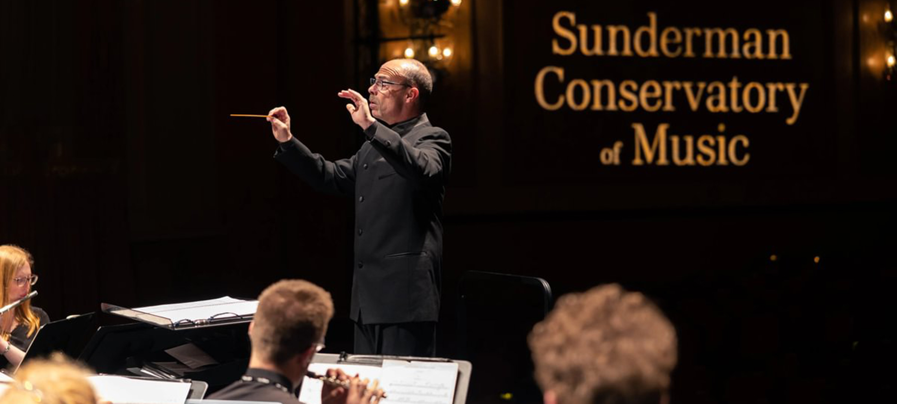 Russell McCutcheon conducting the Wind Symphony during the spring of 2023 