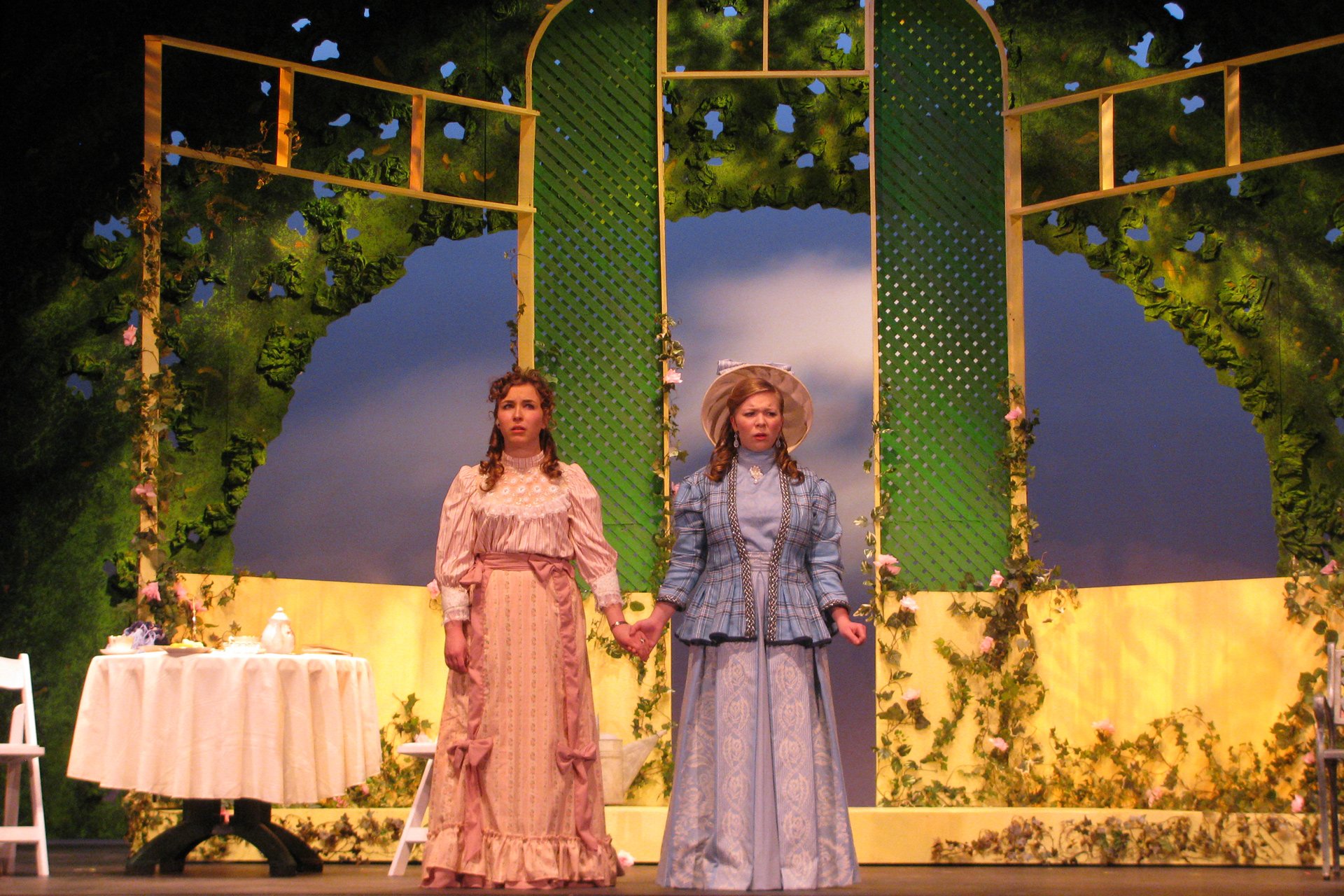 Actresses in period attire holding hands