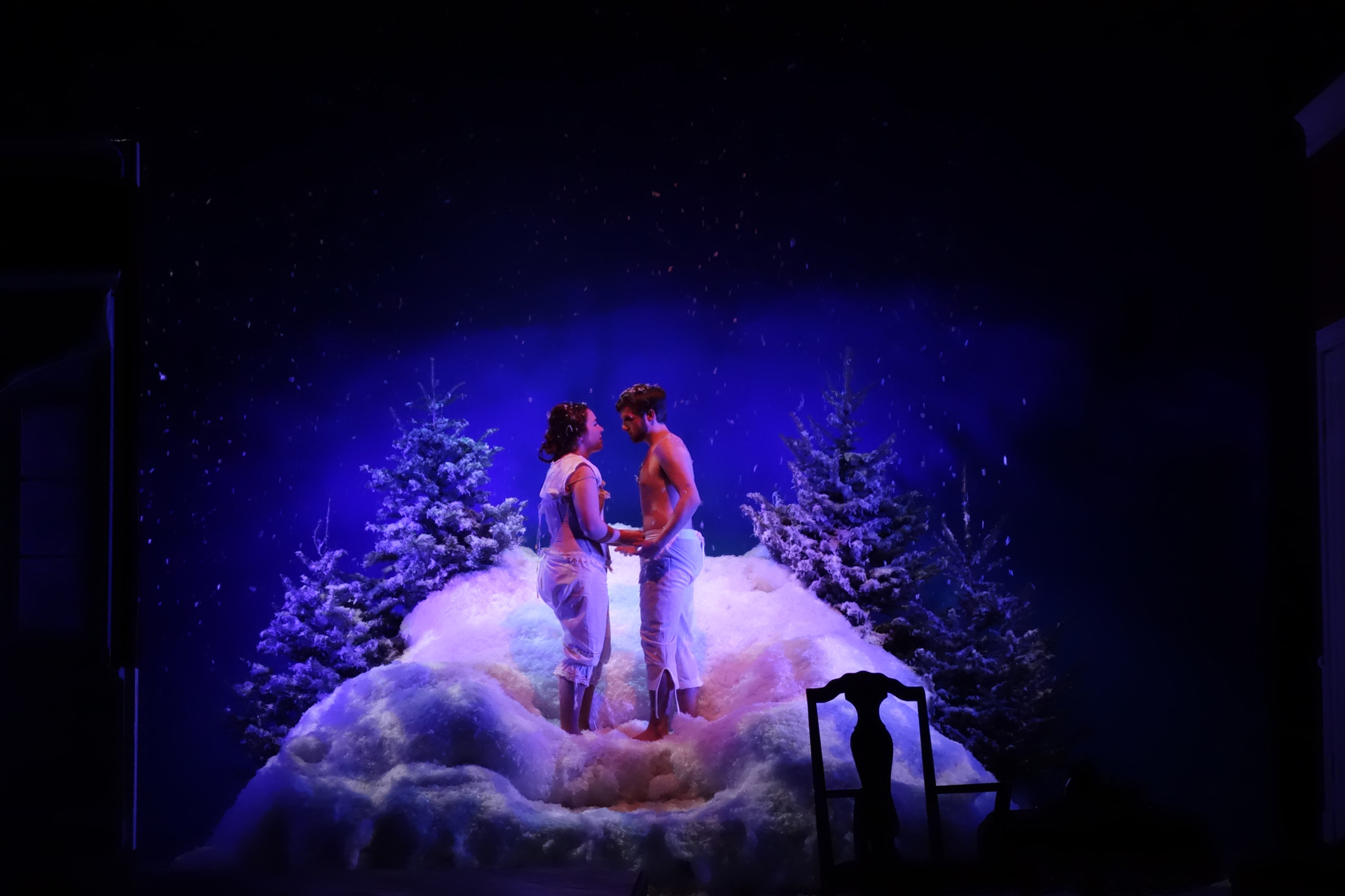 Actor and actress holding hands in the snow