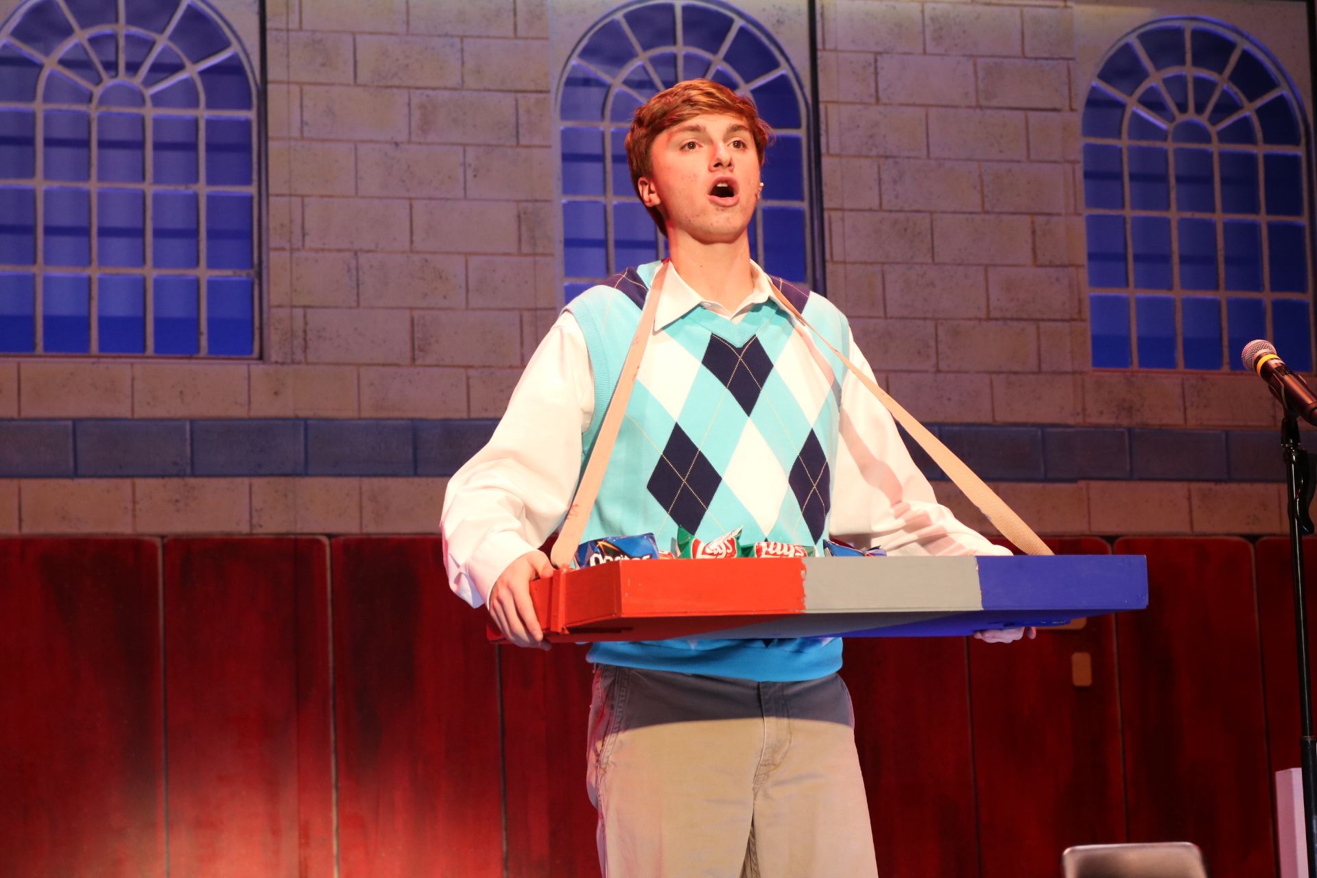 Man singing while holding a tray of food