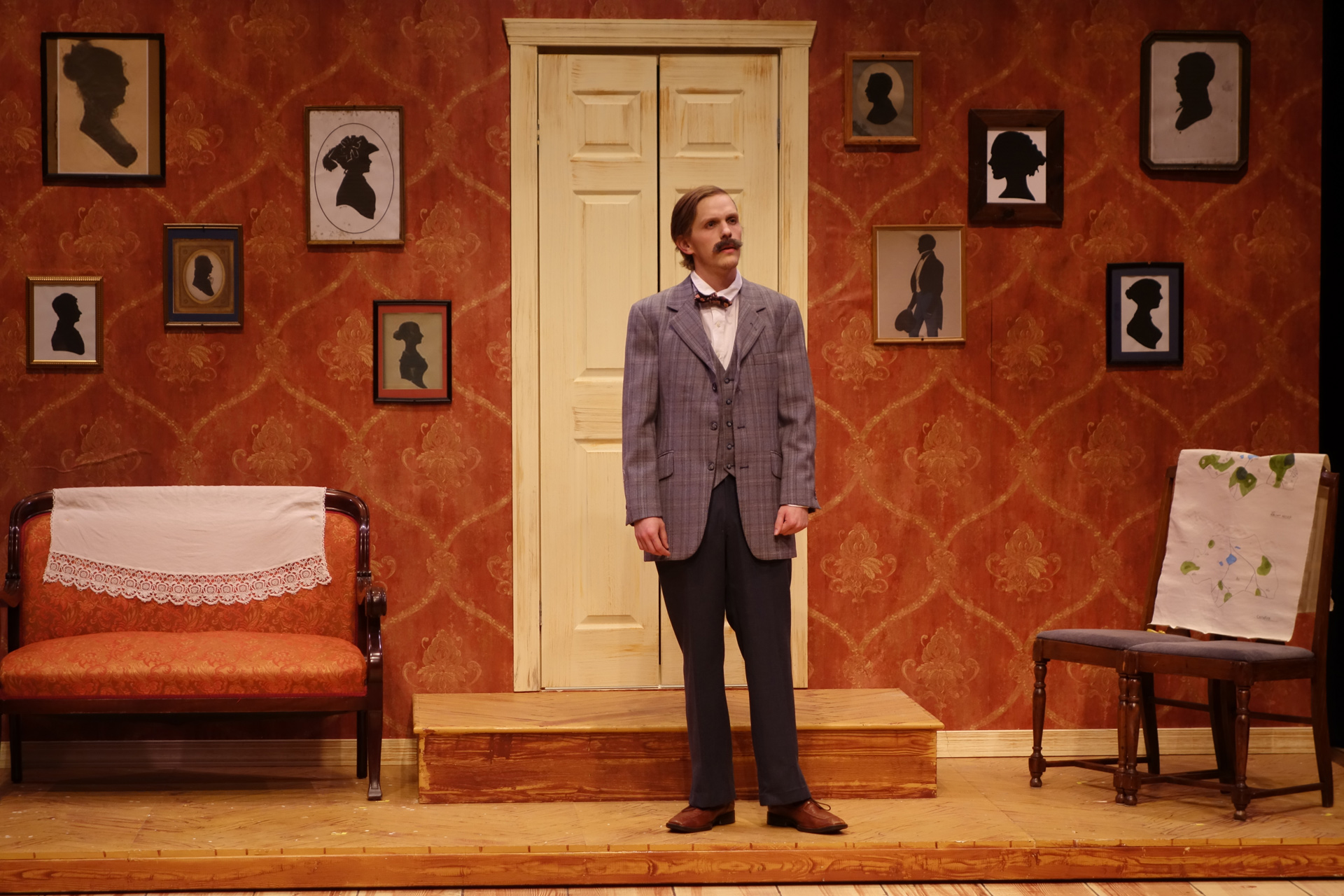 Older man with suite standing in a victorian house