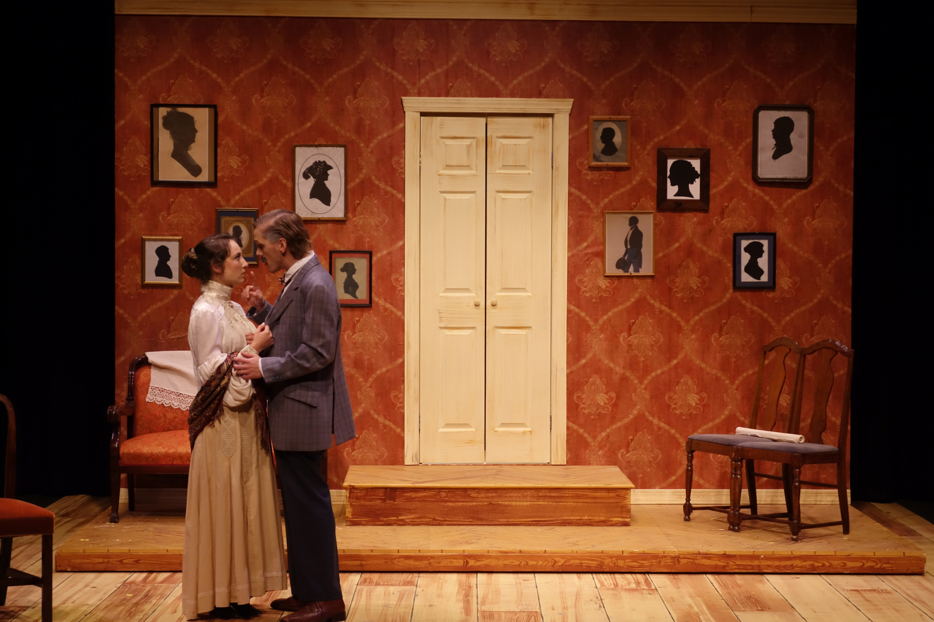 Actor embracing young actress in period attire