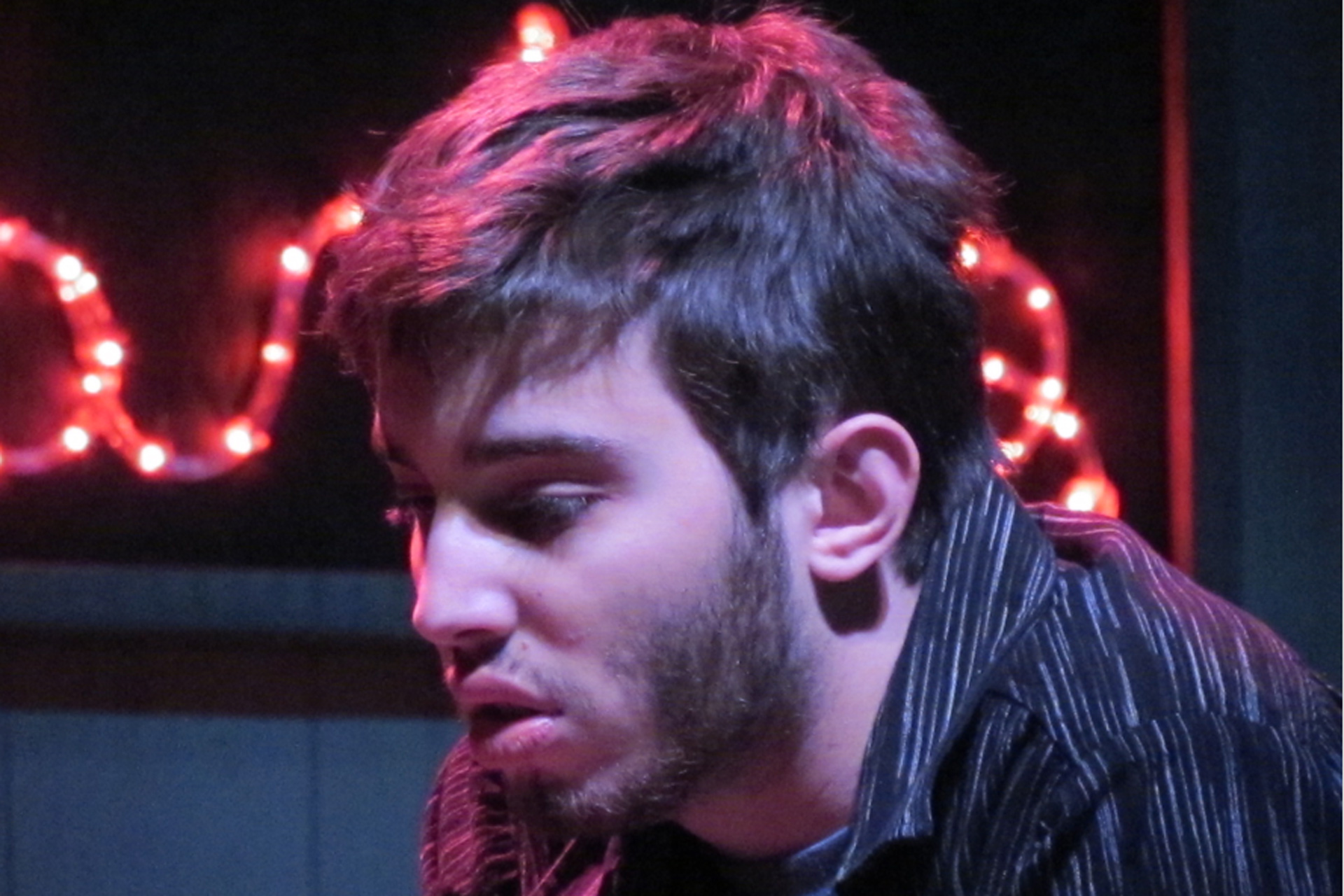 Close up of actor with lights behind him