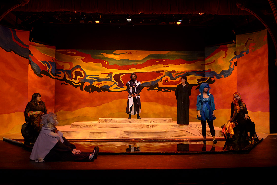 Woman standing on a platform surrounded by a colorful stage