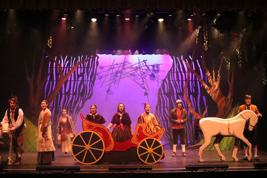 Students on stage with a horse and buggy