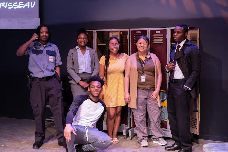 Actors and actresses standing in front of a row of lockers