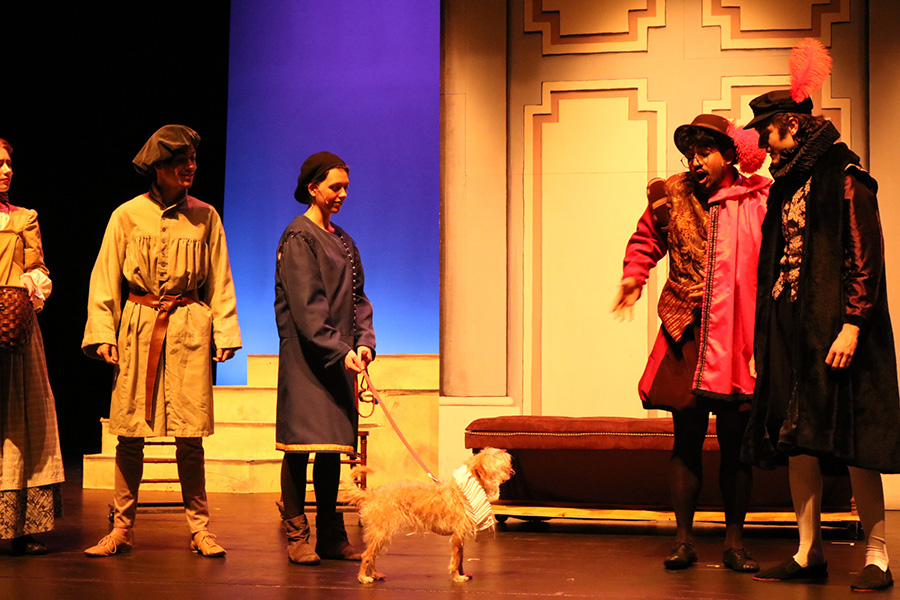 Lady standing with a dog on stage