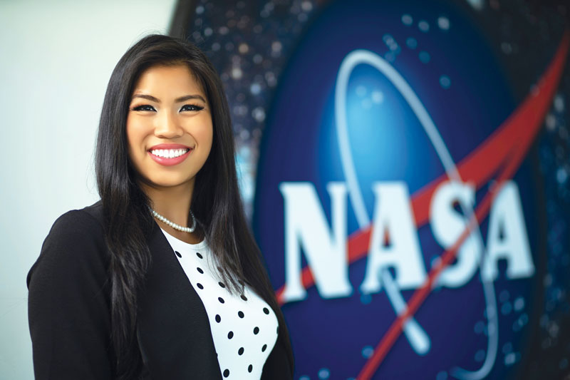Headshot of Alyssa Kaewwilai posing in front of NASA logo