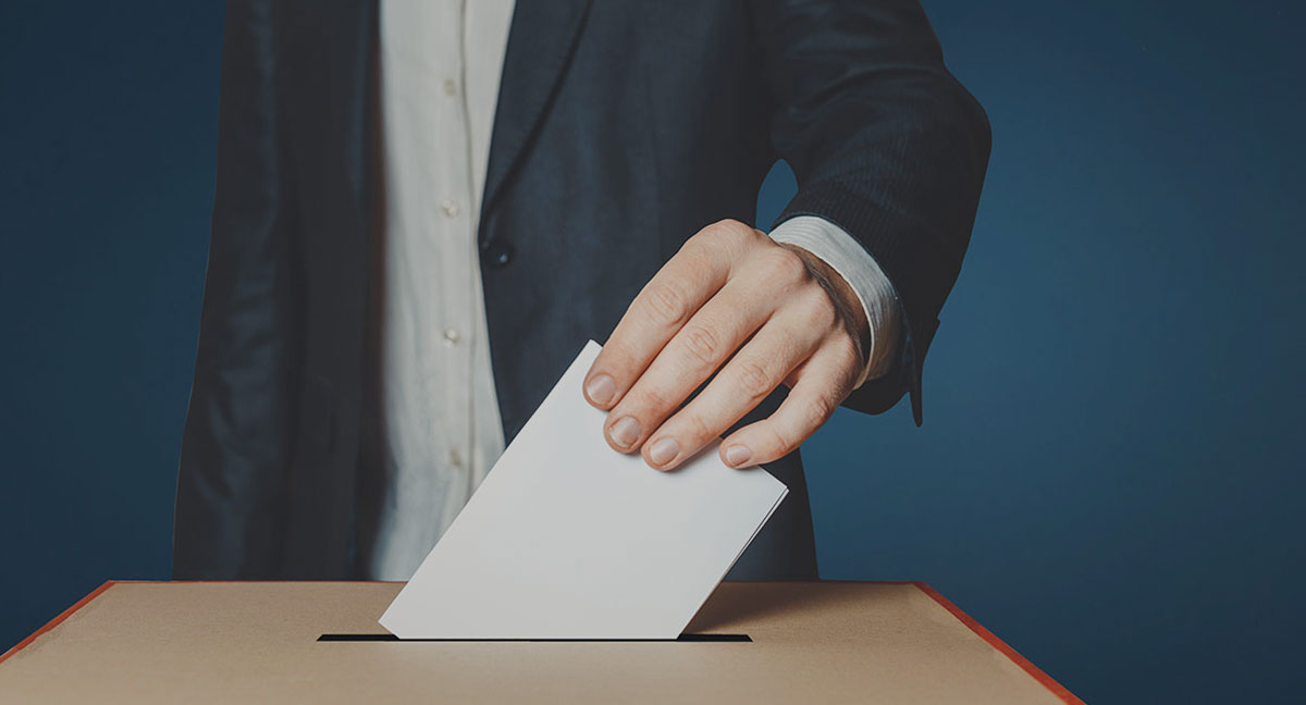 Image of person placing a ballot in a ballot box