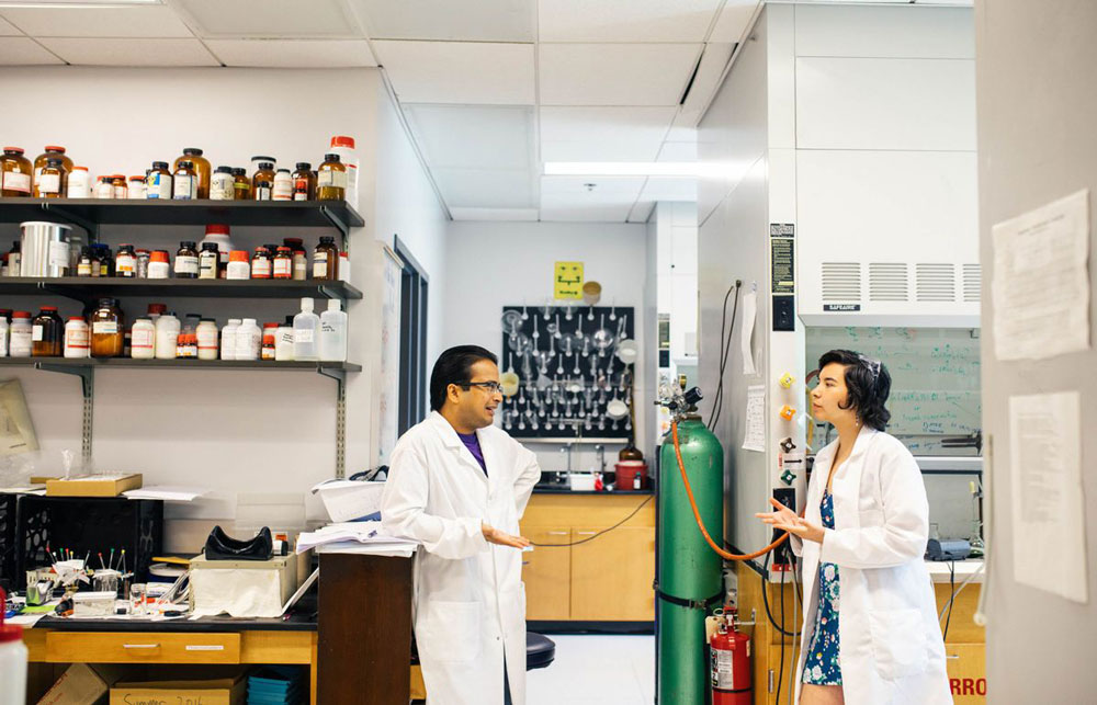 Student working with Professor on research in a science lab