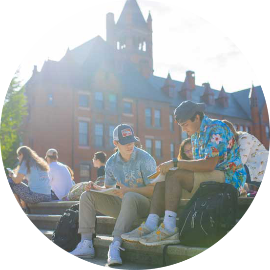 Students sitting and studying on steps outdoors