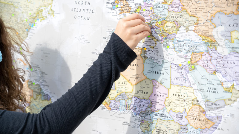 Student with map of the world