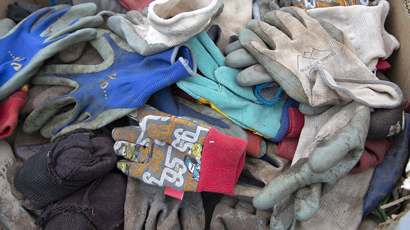 Pile of worn-out work gloves used in a community service project