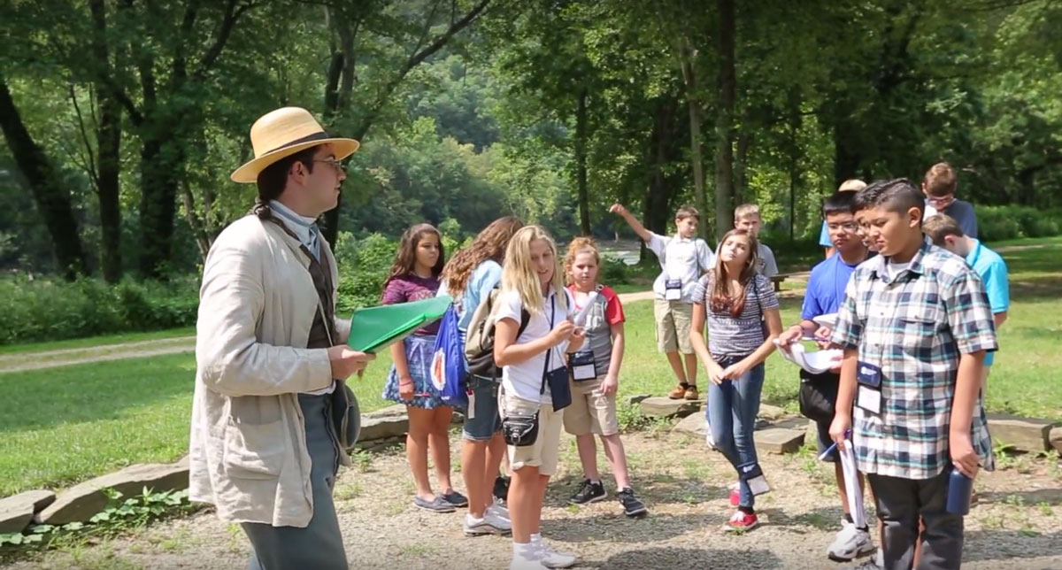 Matt LaRoche 17 leading an outdoor activity session with many young children