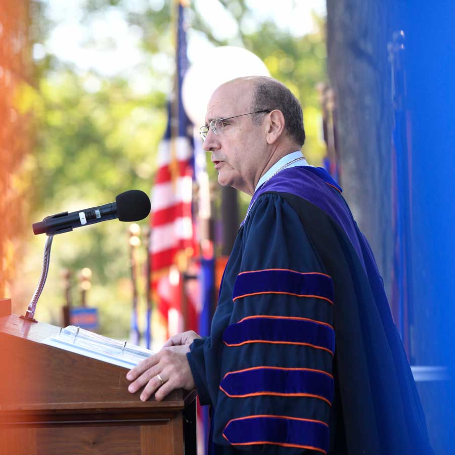 Bob Iuliano speaking at the podium at Commencement