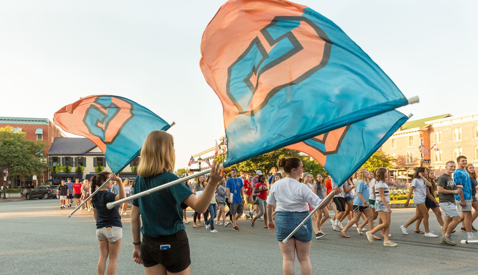 students waving Gettysburg G flags as Class of 2022 walks though Lincoln Square