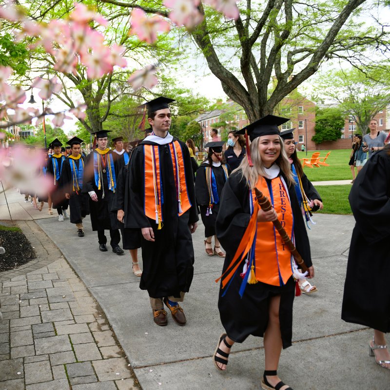 A group of graduates walking into the hall