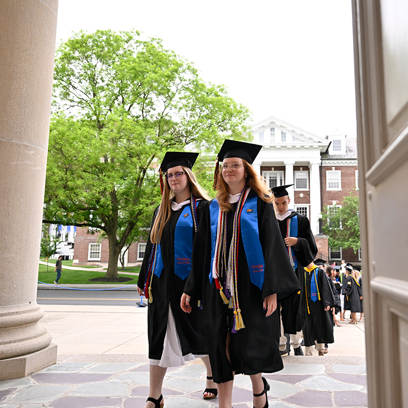 Student standing up in Commencement