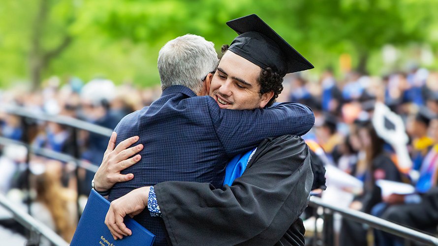 A picture of a graduate hug his father
