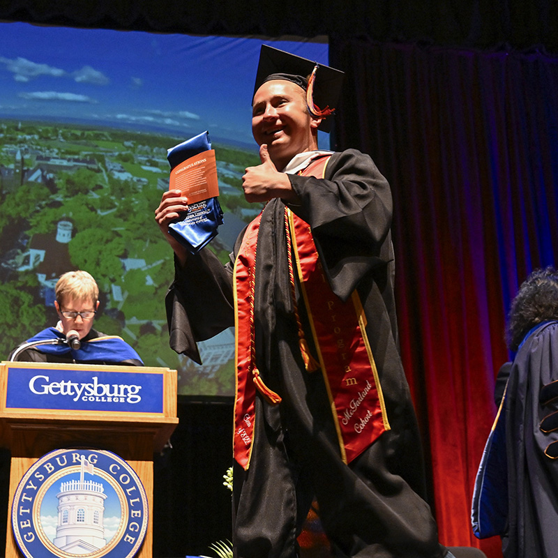 Graduate walking off the stage